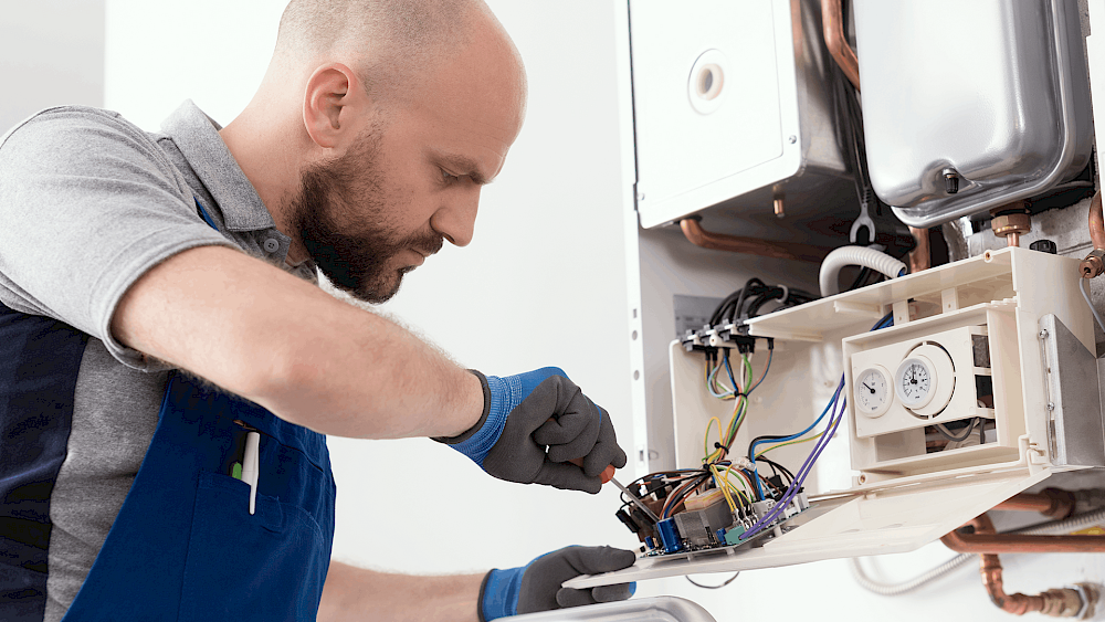 Gas Safe engineer carrying out boiler servicing - request a quote
