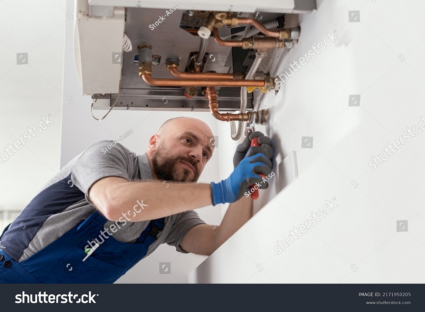Boiler Repairs - stock-photo-professional-engineer-installing-a-natural-gas-boiler-at-home-he-is-checking-the-pipes-2171950205