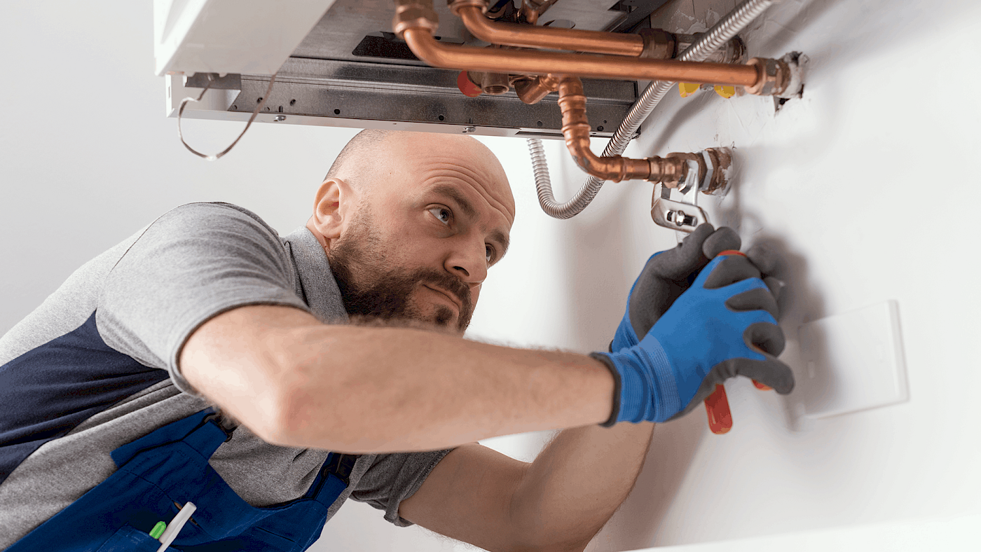 Heating engineer installing central heating system - request a quote