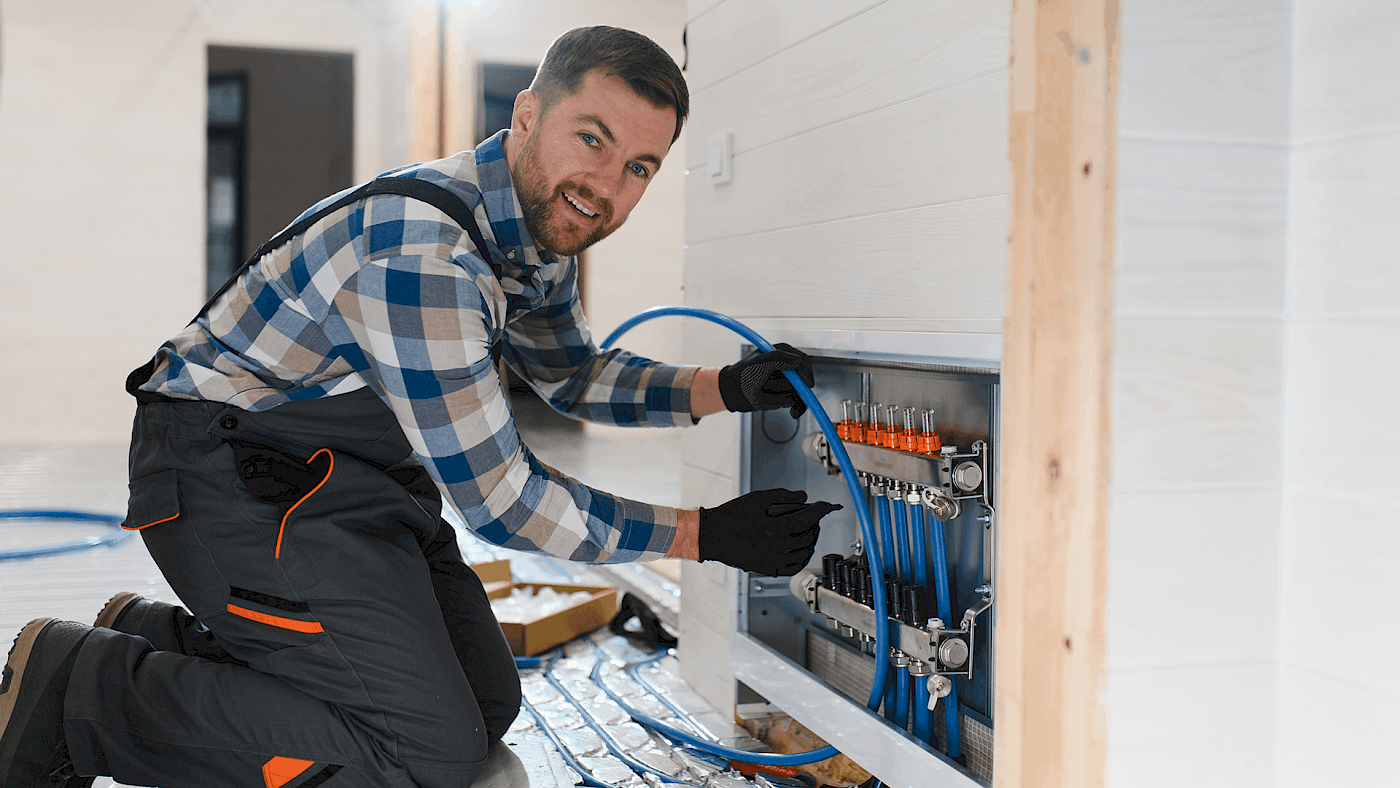 Gas Safe engineer working on central heating pipes - request a quote