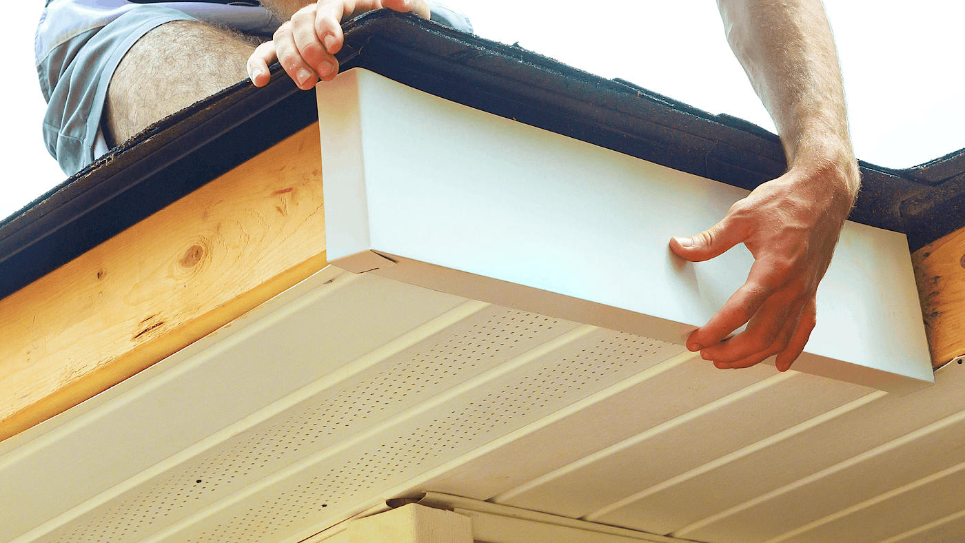 Installer fitting new guttering and fascia boards - request a quote