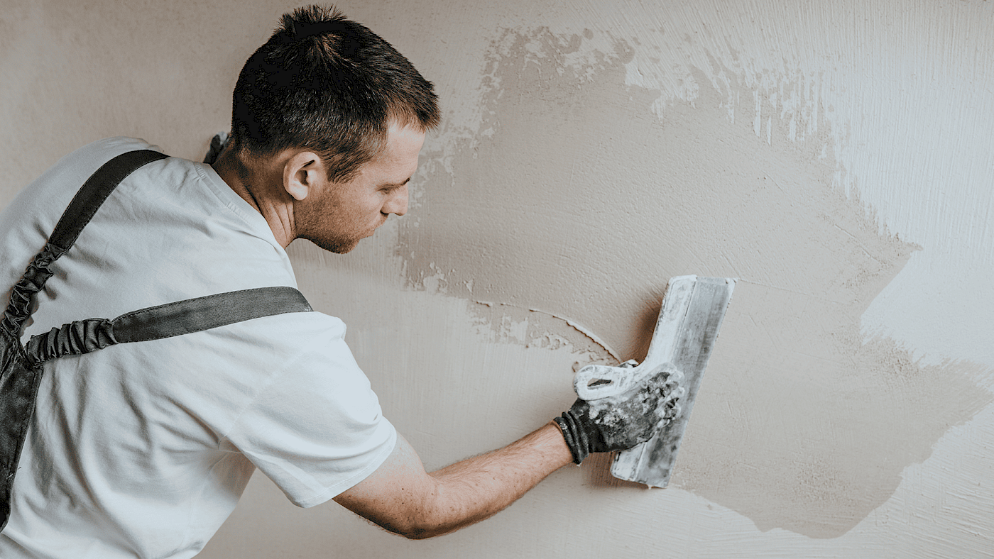 Plasterer finishing ceiling and wall surfaces - request a quote