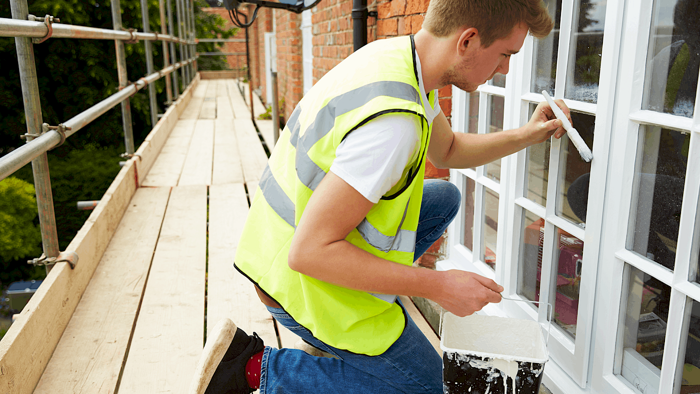Painter working on outside wall painting - request a quote